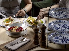Two people enjoy creative Bavarian dishes made with fresh ingredients in a stylish atmosphere.